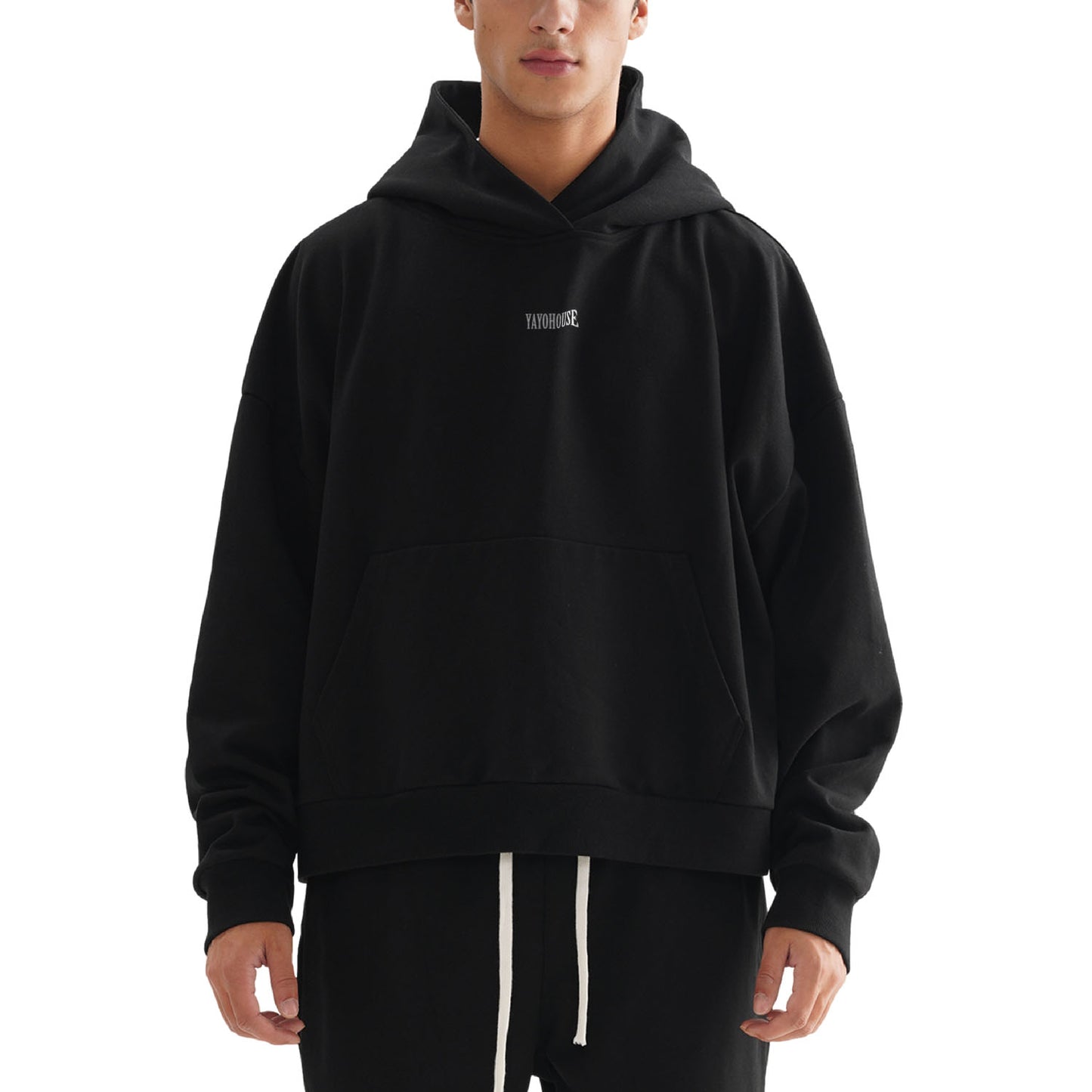 Person in a black hoodie with a front pocket.