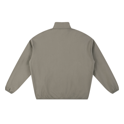Back view of a khaki jacket with a stand-up collar.