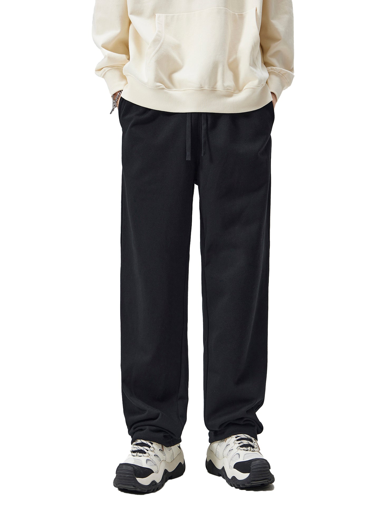 Person wearing a white sweatshirt and black pants on a white background