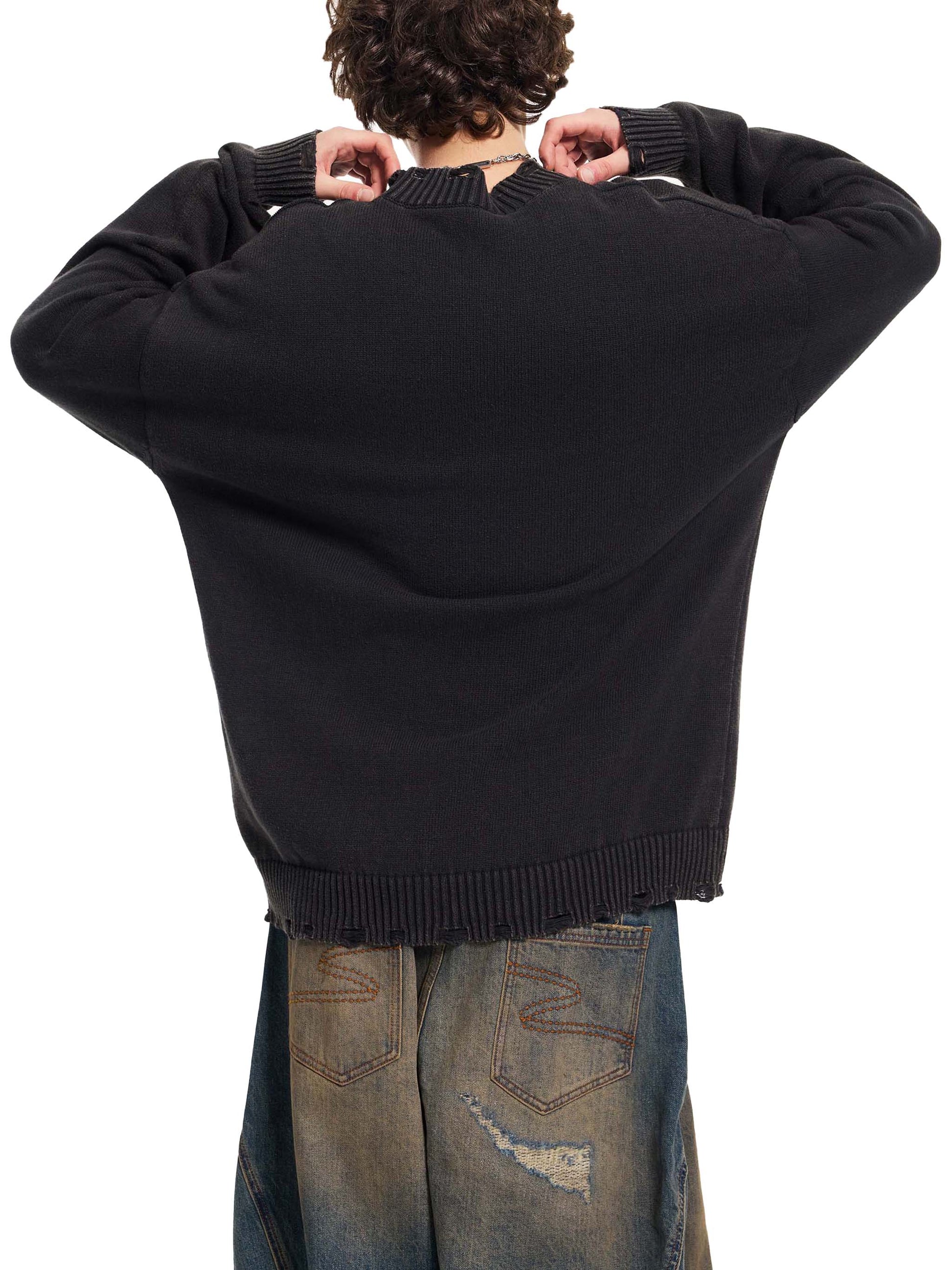 Person wearing a black sweater and jeans from behind on a white background
