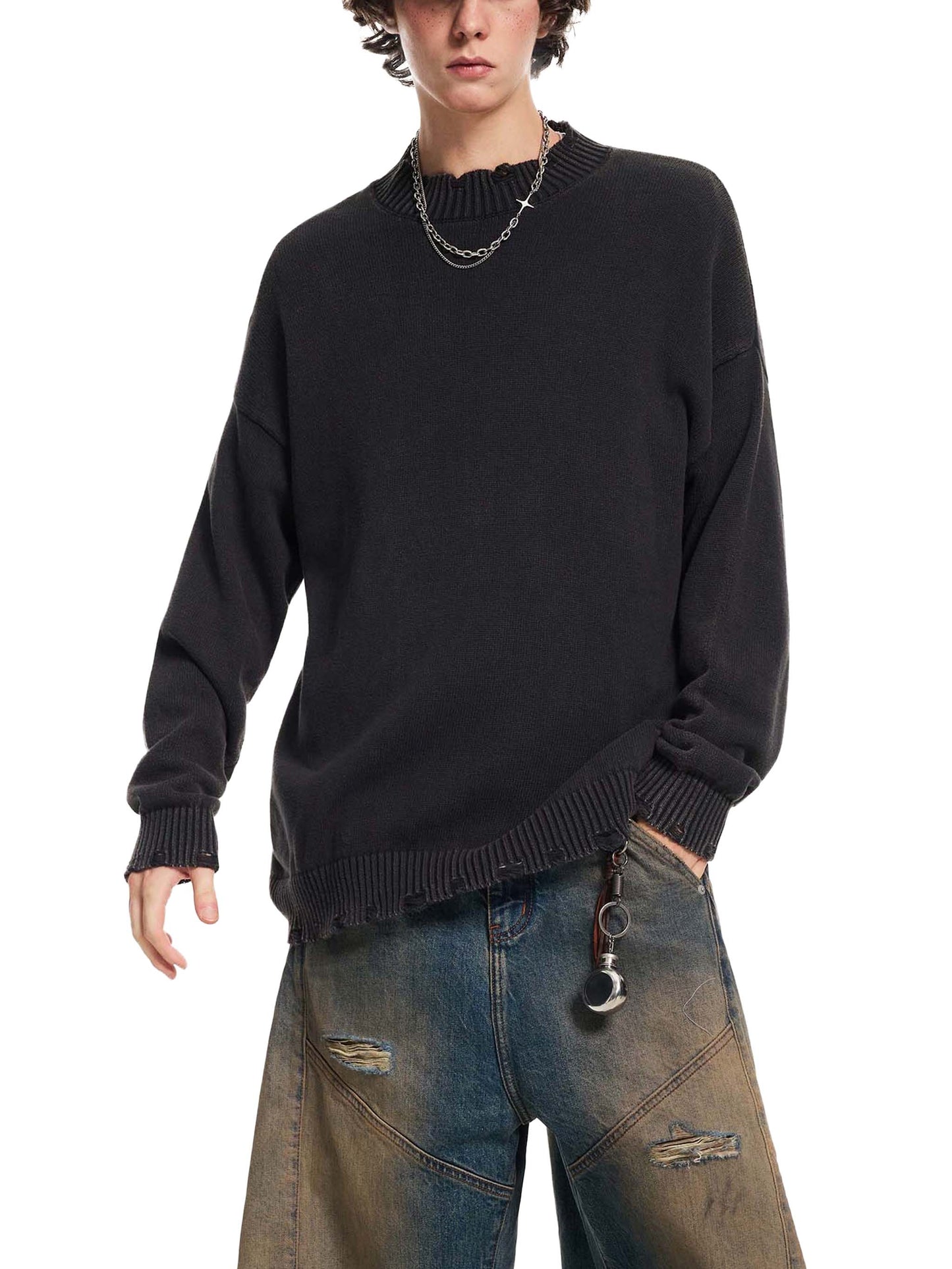Person wearing a black sweater and blue jeans on a white background