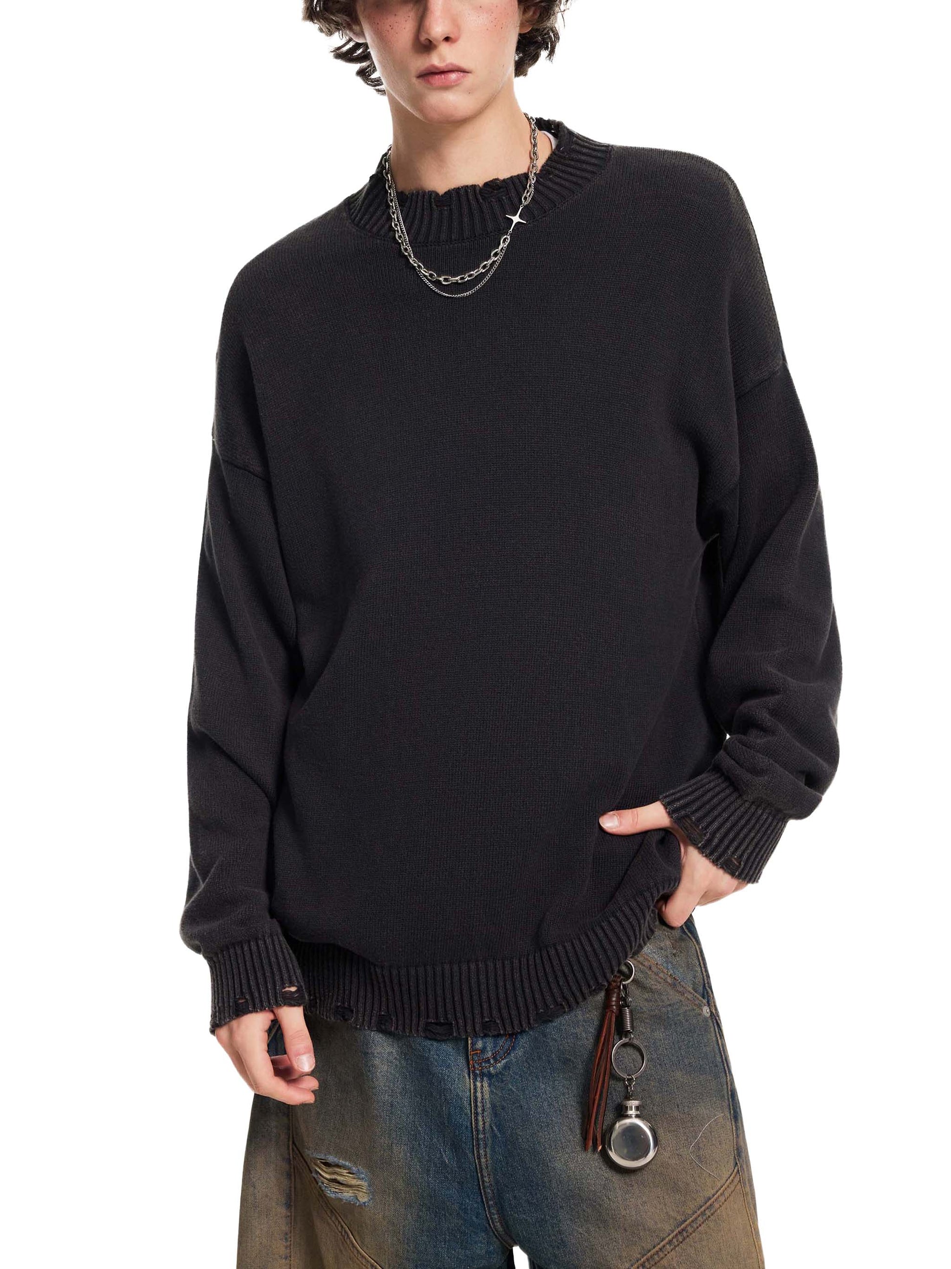 Person wearing a black sweater with a white background