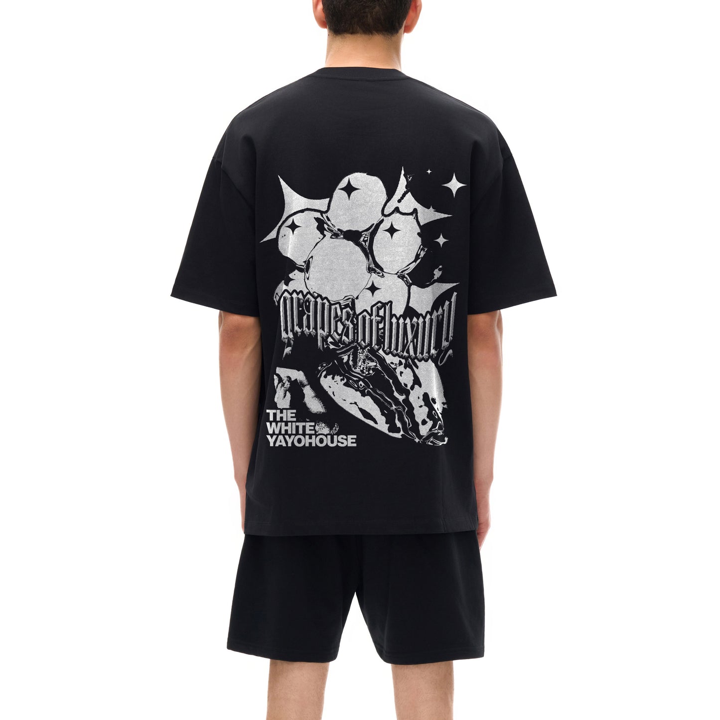 Back view of a person wearing a black t-shirt and shorts.
