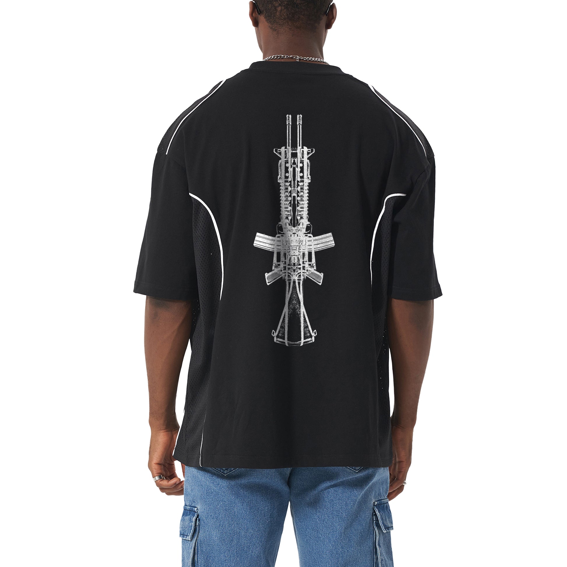 Man in black t-shirt with a gun graphic and blue jeans from behind.