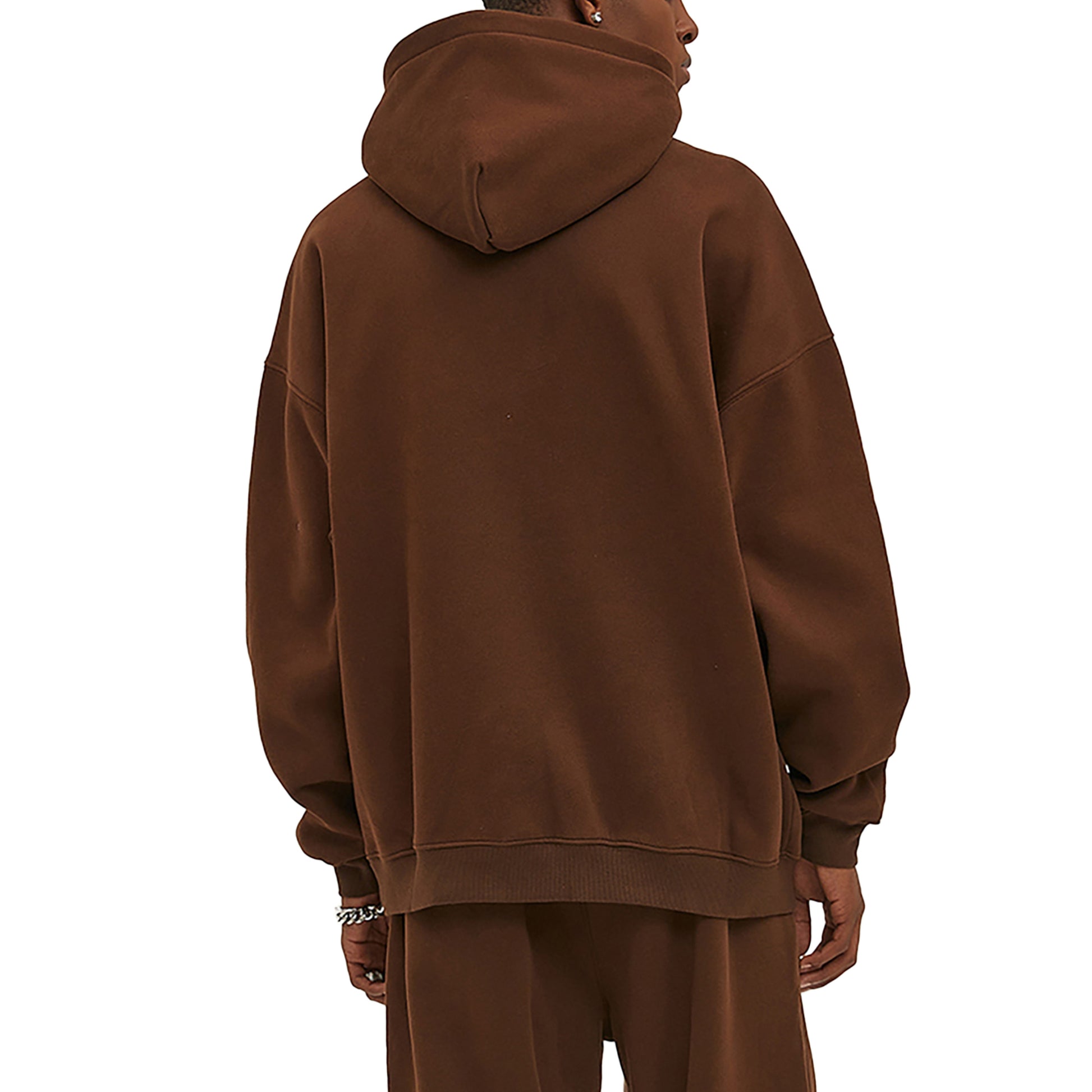 Back view of a person wearing a brown hoodie and pants.