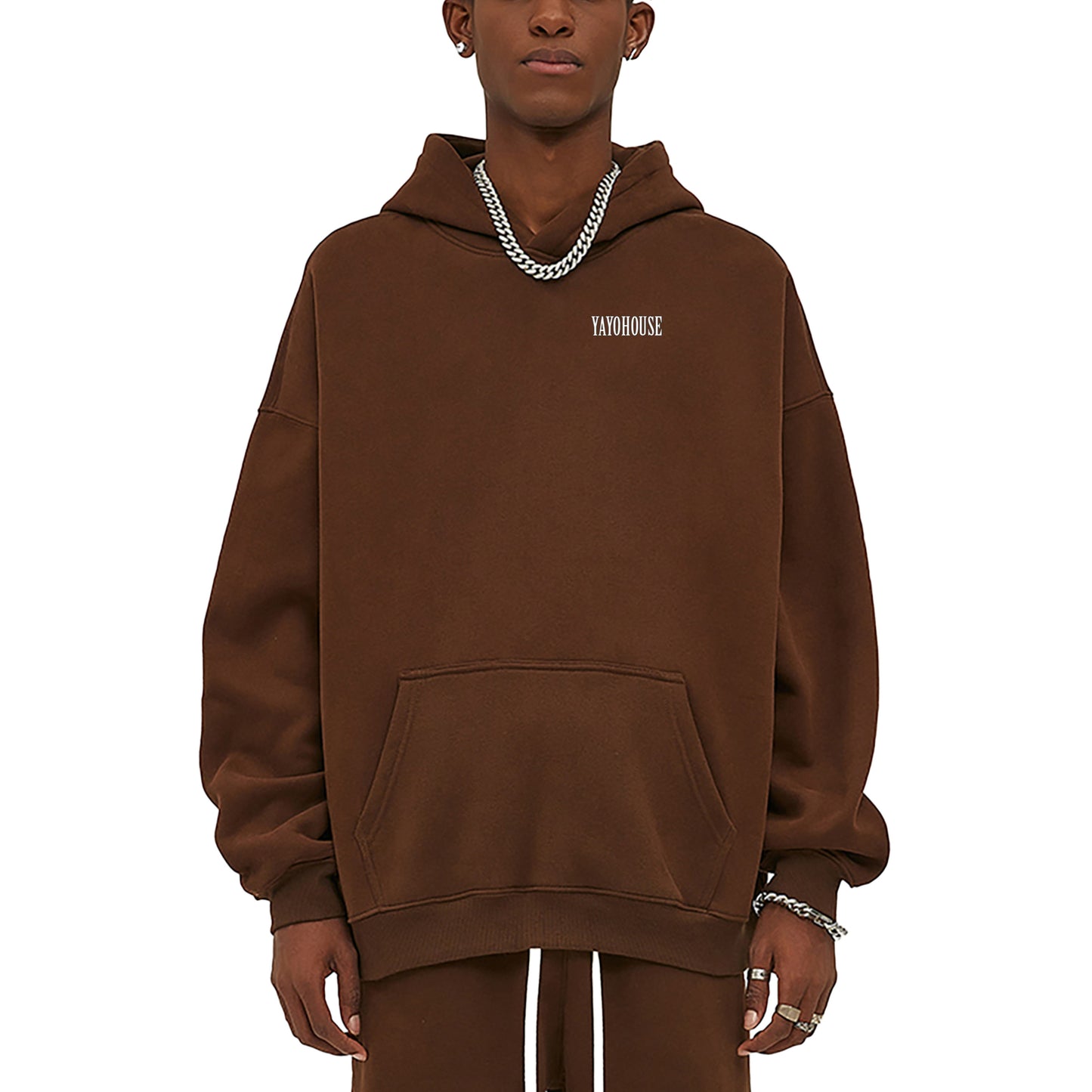 Person wearing brown hoodie and silver chains.