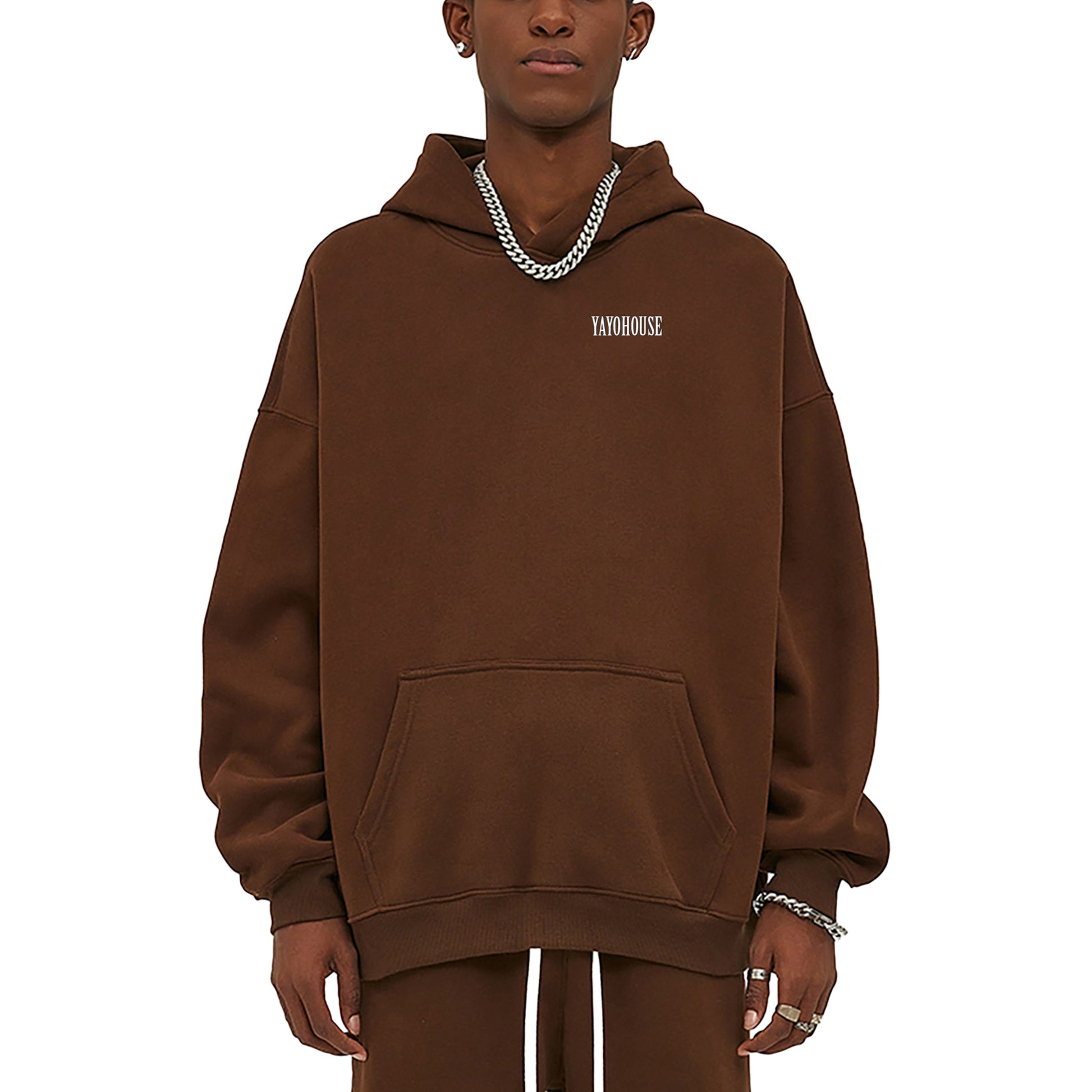 Person wearing brown hoodie and silver chains.