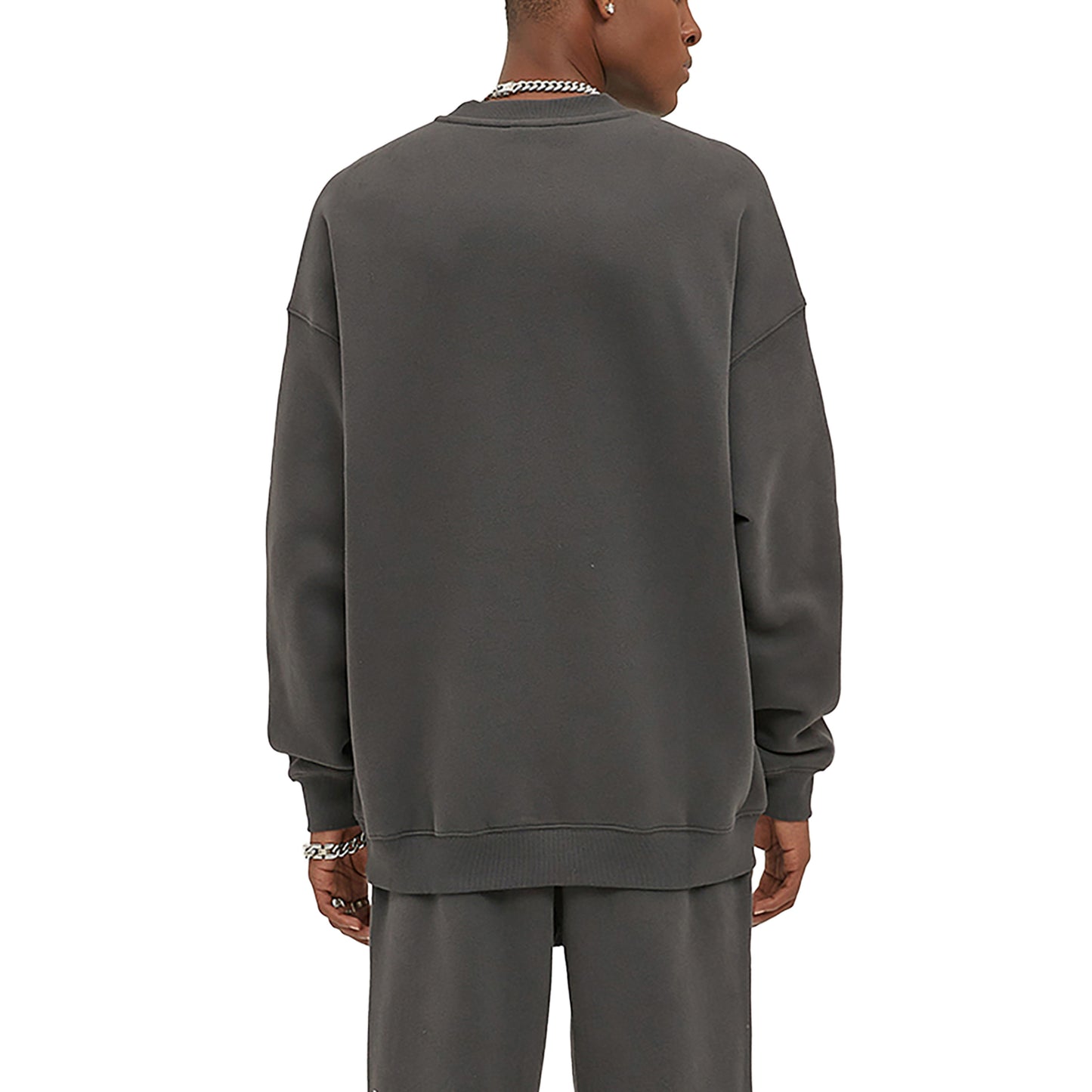 Back of person wearing gray sweatshirt and matching pants.