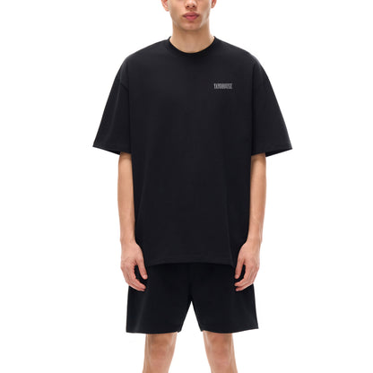 Person wearing a black T-shirt and shorts.