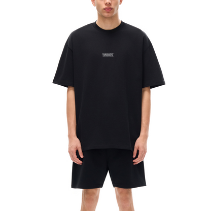 Man in matching black T-shirt and shorts.