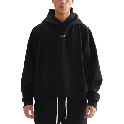 Person in a black hoodie with a front pocket.