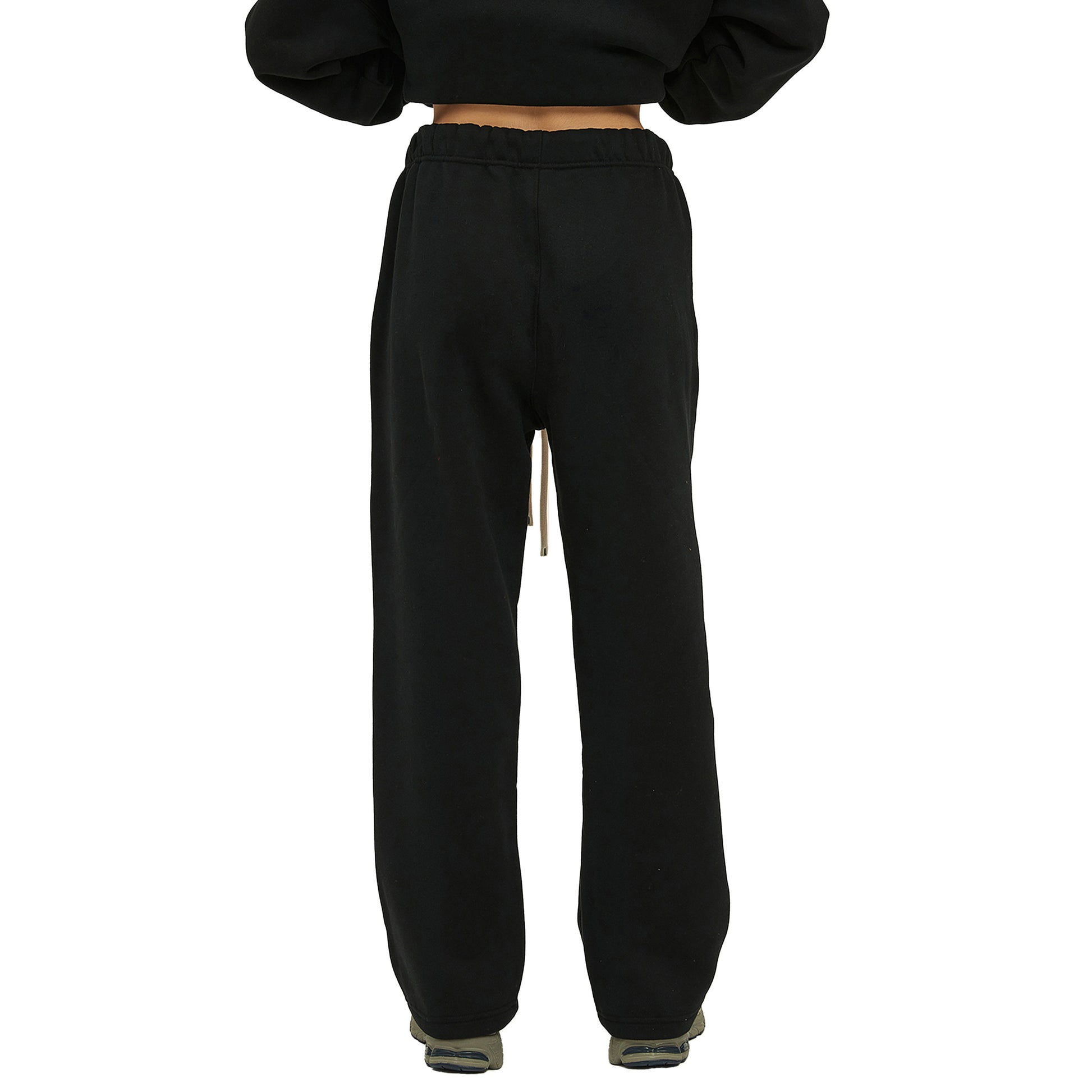 Back view of black sweatpants with a drawstring at the waist.